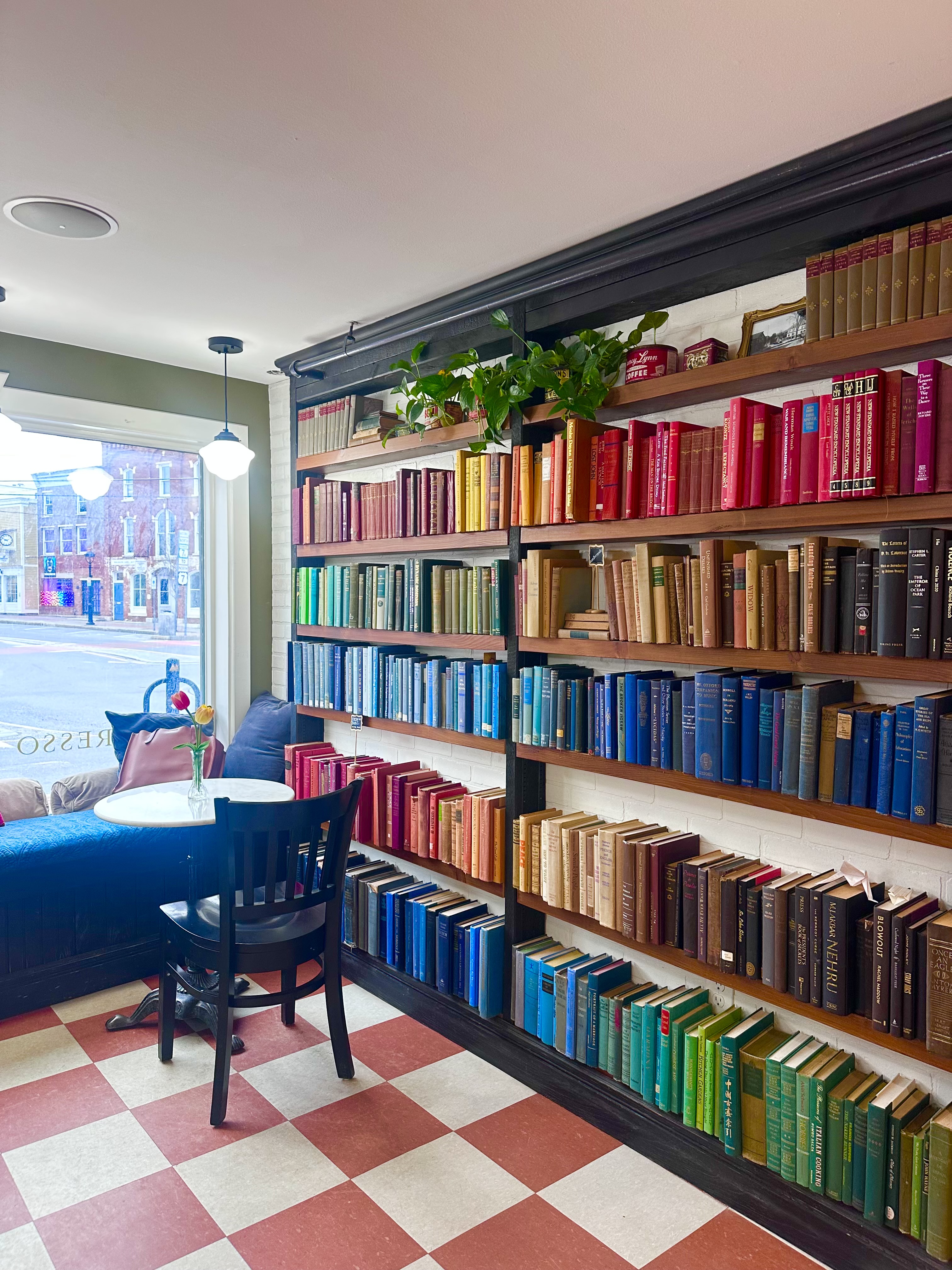 Rainbow bookshelves and cafe seating at Colburn Cafe inside Northshire Bookstore Manchester Vermont